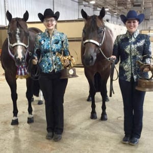 The first World Champion of 2015 was awarded today to Paulina Martz (left), and also pictured is Sammie Johnson who won a bronze trophy in the Performance Halter Geldings with Flashy Invite. Photo courtesy of Judd Paul. 